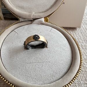 Freida Rothman Gold-Tone Band Ring with Black FR flower symbol.